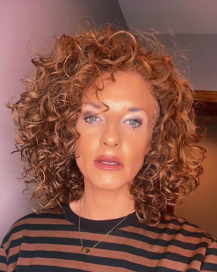 Megg's defined red curls