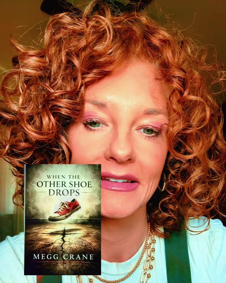 Megg holding a copy of When the Other Shoe Drops