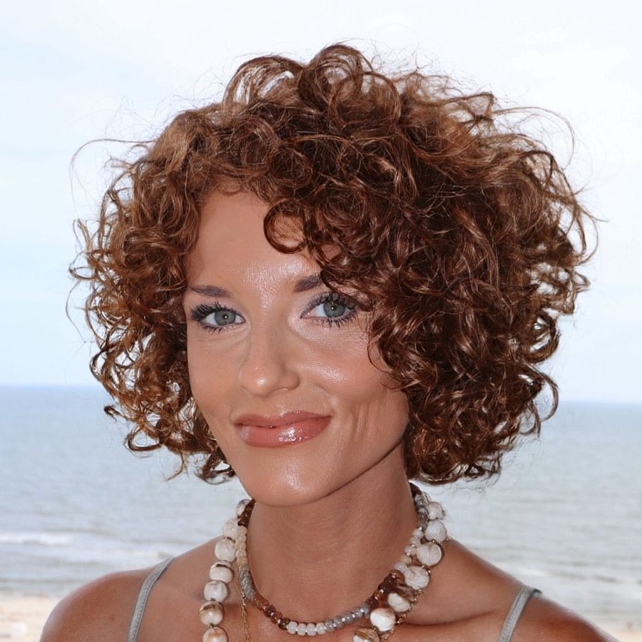 Megg Crane smiling by the ocean